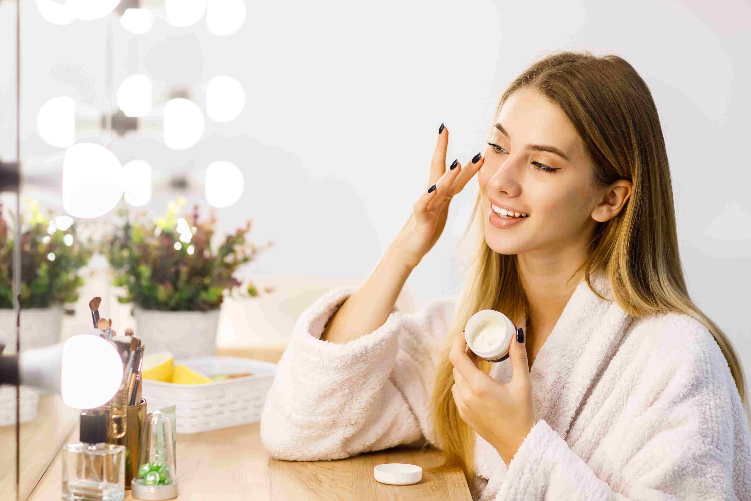 young-beautiful-blonde-girl-cares-face-skin-with-moisturizer