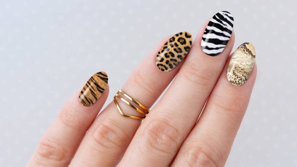 Bold leopard print on a nude background, with glossy topcoat finish
