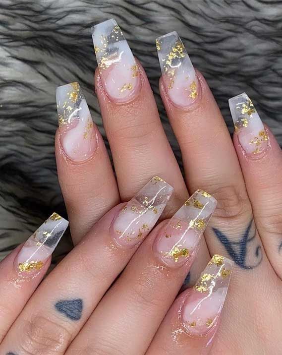White and gray marbled nails with hints of gold flecks